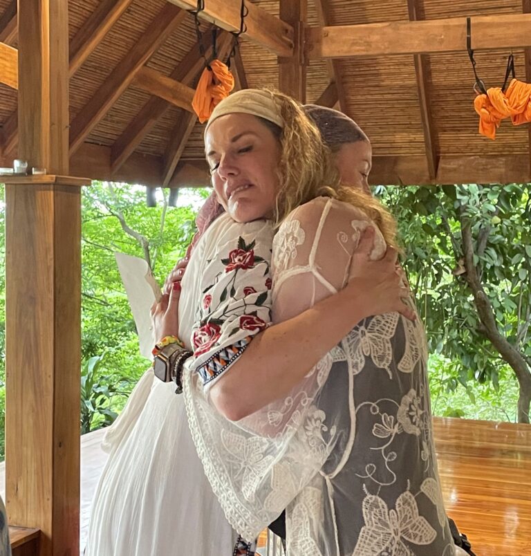 two women hugging at a retreat